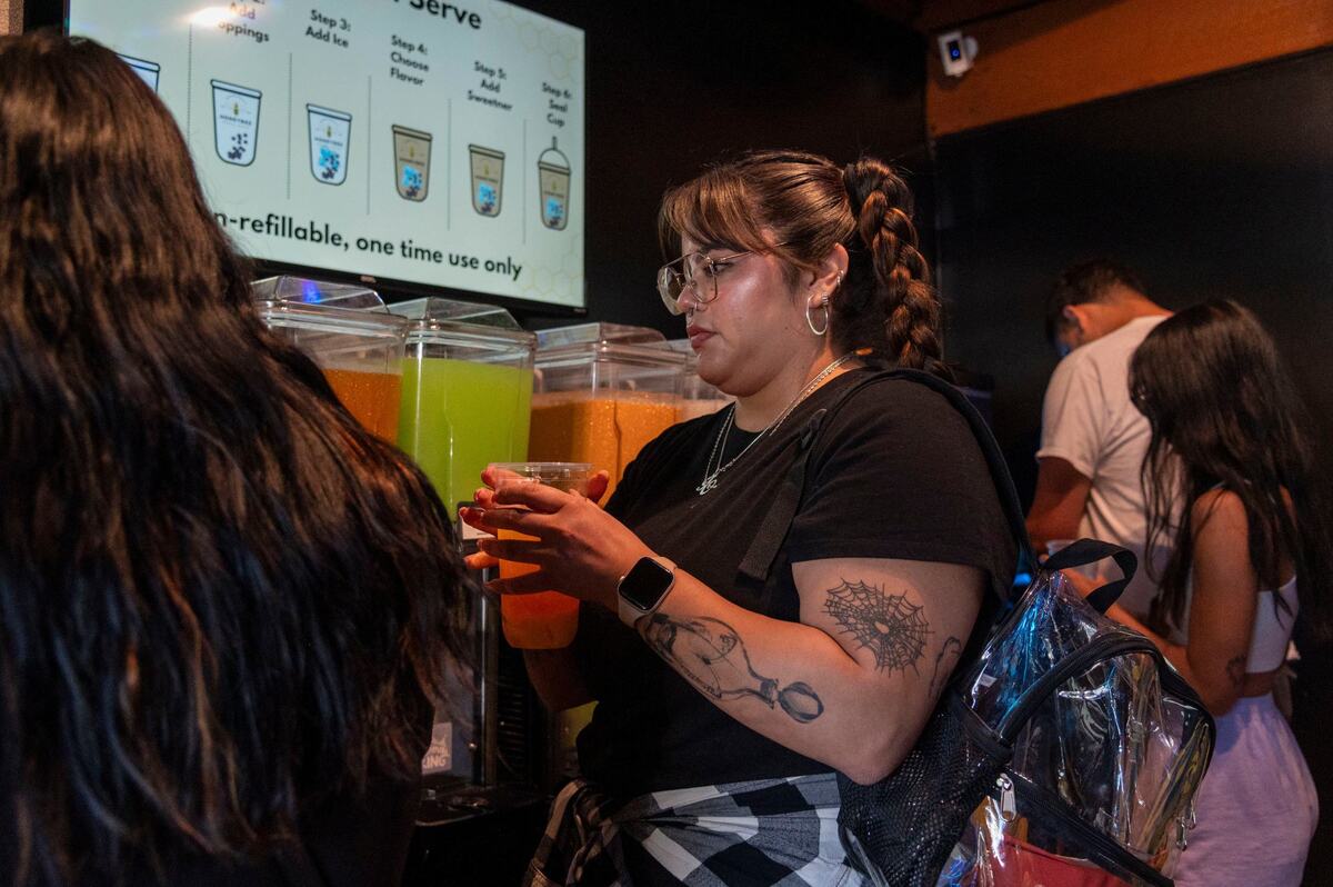 Customer Isa Olivas makes her own fruit tea drink at Honeybee Boba Cafe in East Sacramento on Wednesday.