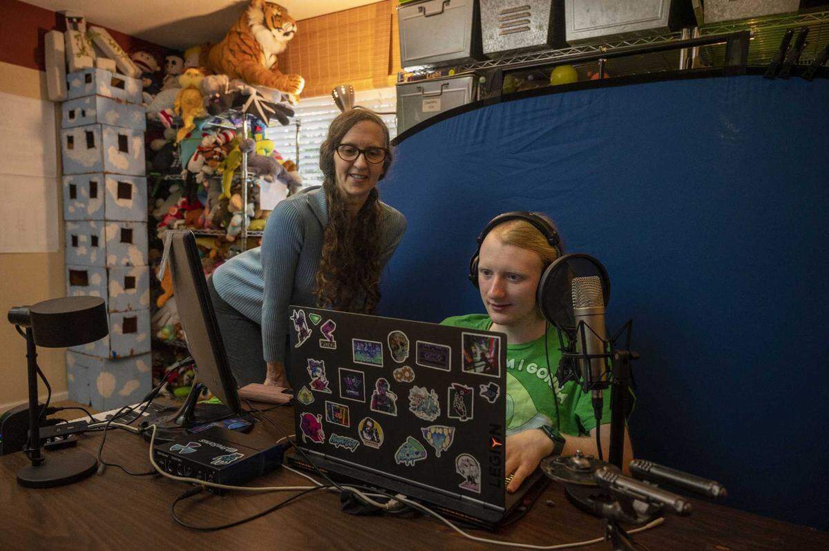 Tiffany Clark checks in on her son, Keegan Clark, while he works on his computer on Oct. 4.