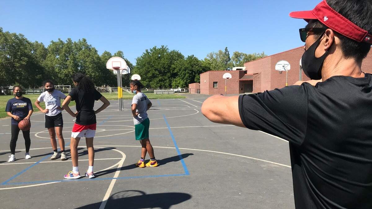 McClatchy girls’ basketball coach Jeff Ota directs his team at an outdoor practice Monday, May 3, 2021.