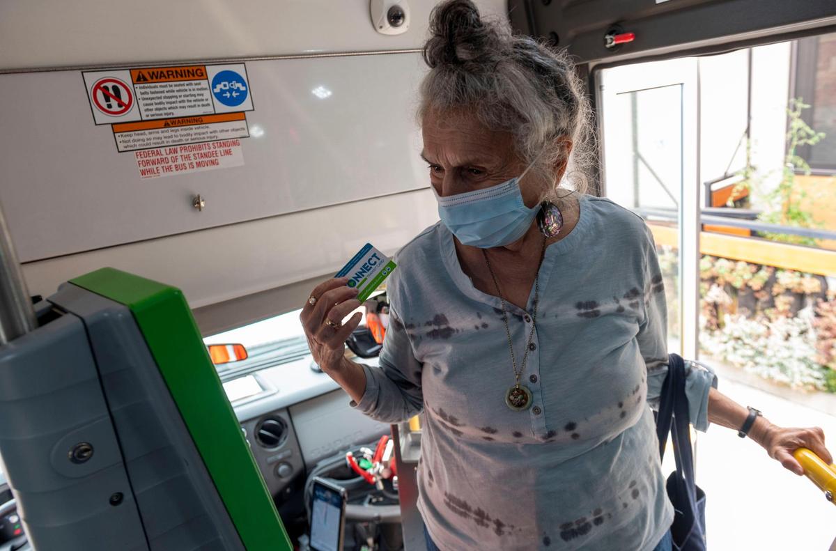 Rosalie Rashid, 81, scans her Connect bus pass after getting inside a SmaRT Ride Sacramento Regional Transit bus on Friday, Sept. 11, 2020. Users can load money onto their Connect card so that they do not have to carry around cash or change.