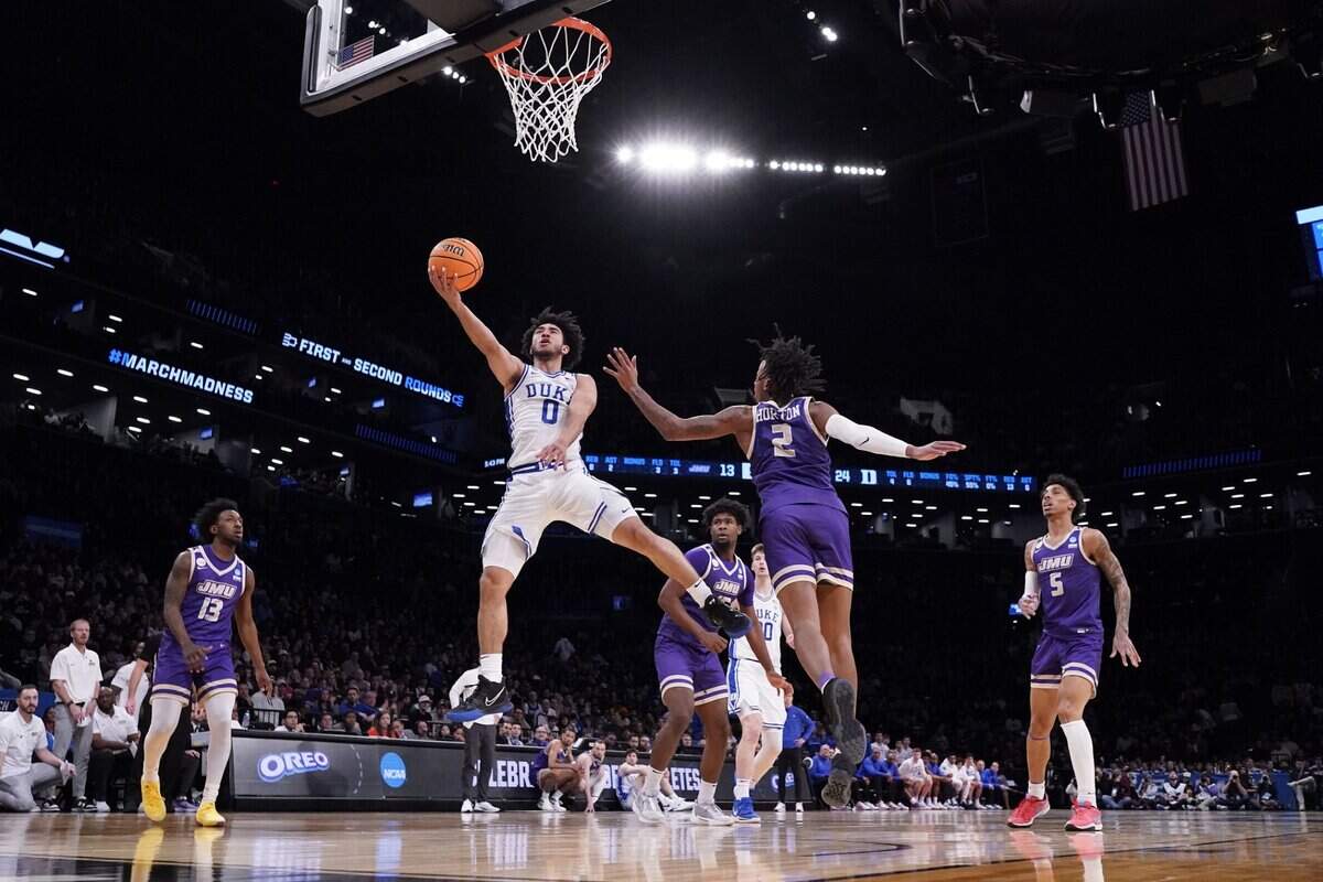 Mar 24, 2024; Brooklyn, NY, USA; Duke Blue Devils guard Jared McCain (0) shoots the ball against James Madison Dukes forward Raekwon Horton (2) in the second round of the 2024 NCAA Tournament  at Barclays Center. Mandatory Credit: Robert Deutsch-USA TODAY Sports