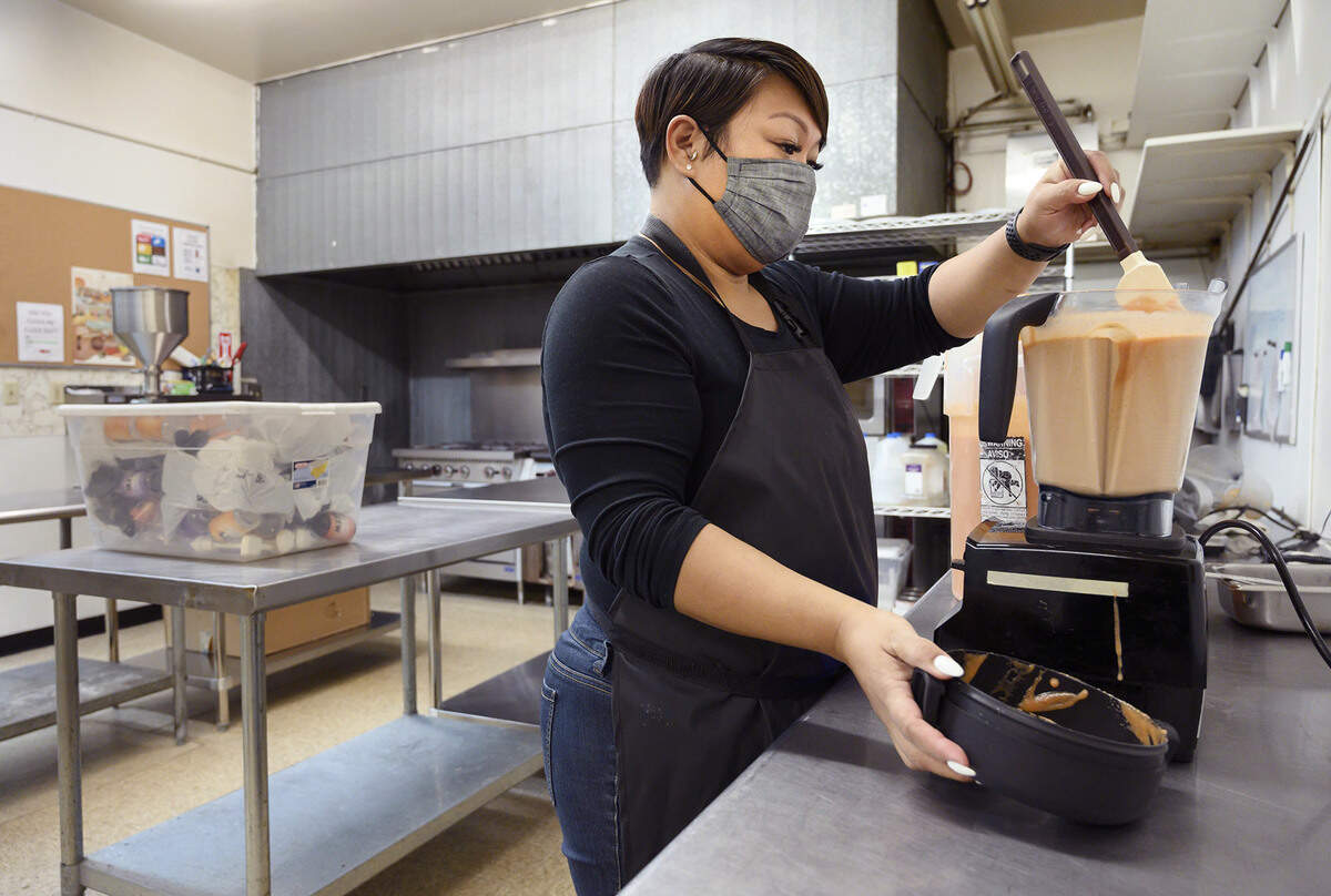Jasmine Bonilla of North Natomas uses a blender to mix up a batch of her Jazz’s Spicy Sauce at Alchemist Kitchen on Dec. 14. 