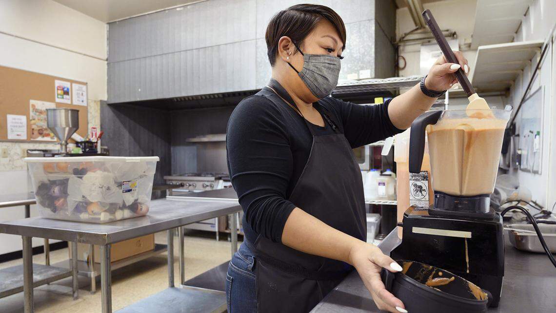 Jasmine Bonilla of North Natomas uses a blender to mix up a batch of her Jazz’s Spicy Sauce at Alchemist Kitchen in Sacramento on Tuesday, Dec. 14, 2021.Alchemist CDC is asking Book of Dreams readers for $7,000 in donations to help purchase a commercial freezer and industrial food processor for shared use in their kitchen space.
