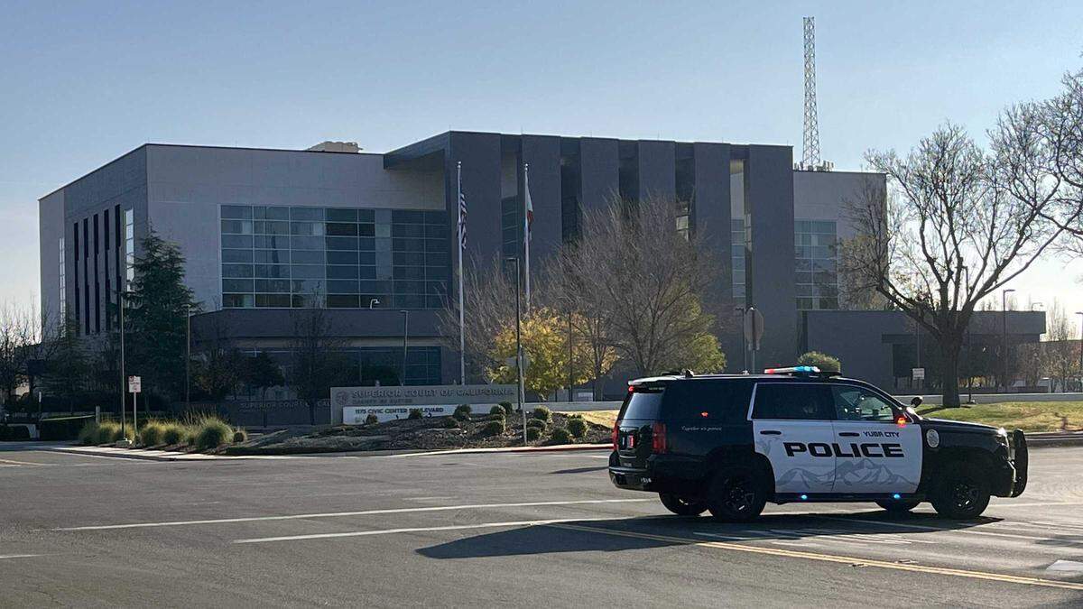 Yuba City Police patrol vehicles stand guard outside the Sutter Superior Court building in Yuba City on Tuesday, Dec. 10, 2024, following a bomb threat. Authorities have closed the courthouse for the day and issued a shelter-in-place order for several buildings nearby.