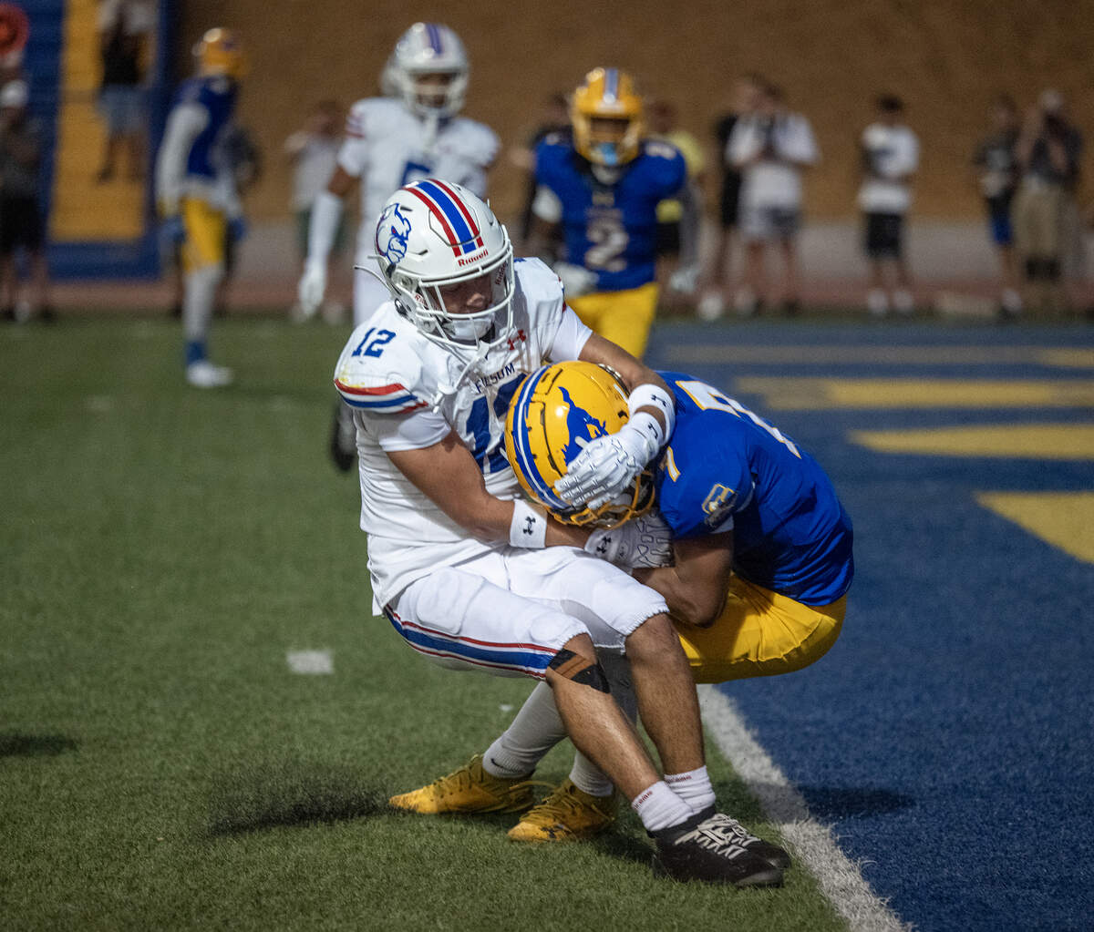 The Folsom Bulldogs’ Adin Steward (21) is unable to keep the Grant Pacers’ Tavio Rios (7) from crossing into the end zone in the first half on Saturday in Del Paso Heights.