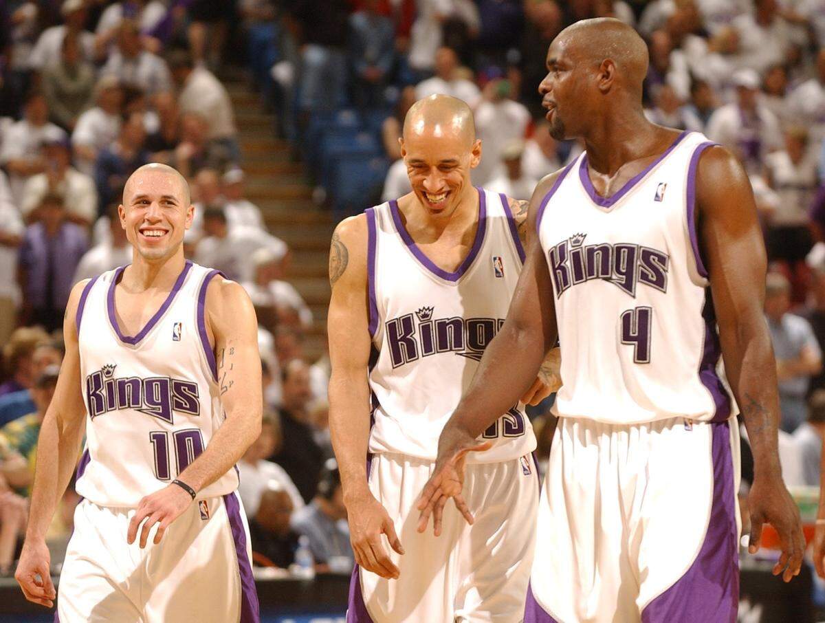 The Sacramento Kings' Mike Bibby, Doug Christie and Chris Webber smile after Game 1 of the 2003 NBA Western Conference Playoffs against the Utah Jazz at Arco Arena in Sacramento on April 19, 2003.