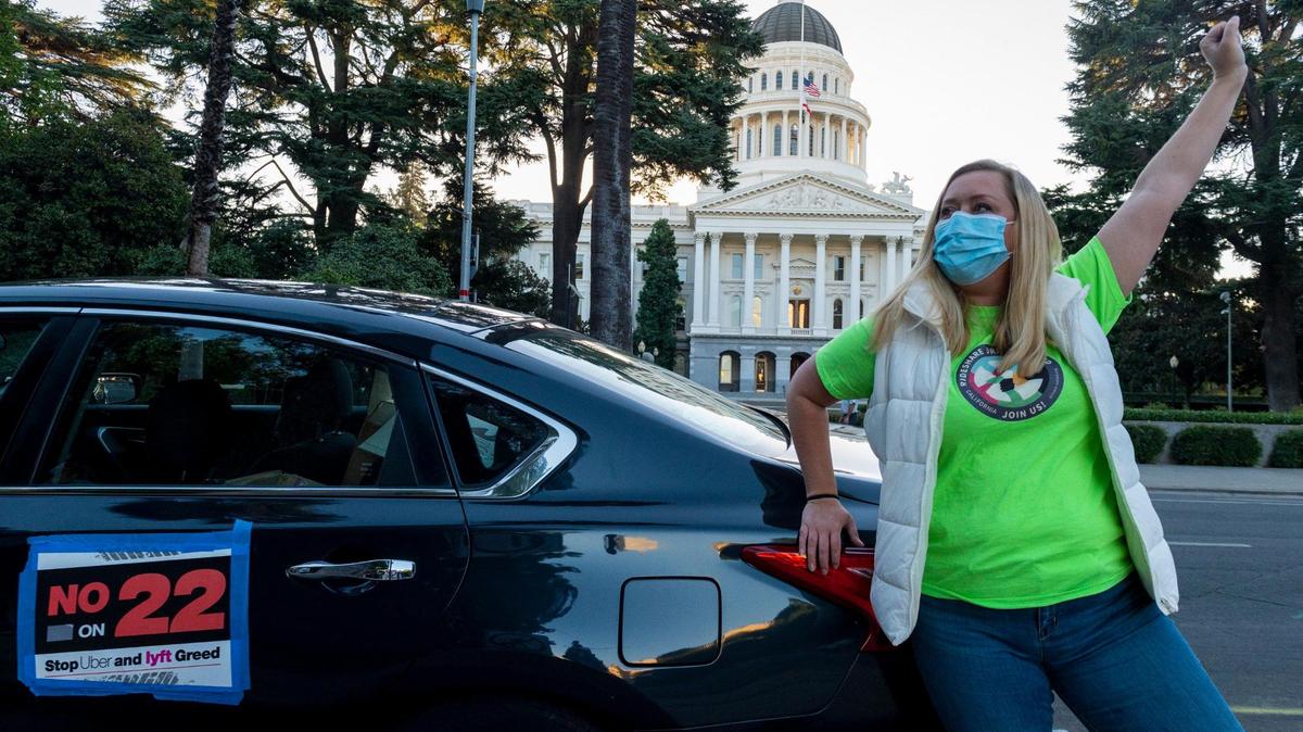 Erica Mighetto, an Uber and Lyft driver, demonstrates at the state Capitol in Sacramento at a gig workers rally against Proposition 22 in October 2020.