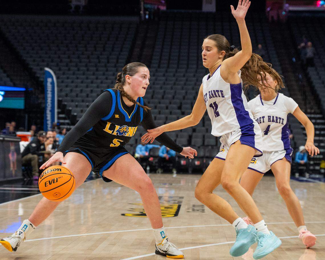 Faith Christian Lions guard Lauren Harris (5) dribbles as the Bret Harte Bullfrogs’ Maddie Kane (12) defends in the CIF Sac-Joaquin Section Division V girls basketball championship at Golden 1 Center on Saturday. The Lions are the top seed in the NorCal Division IV bracket. 