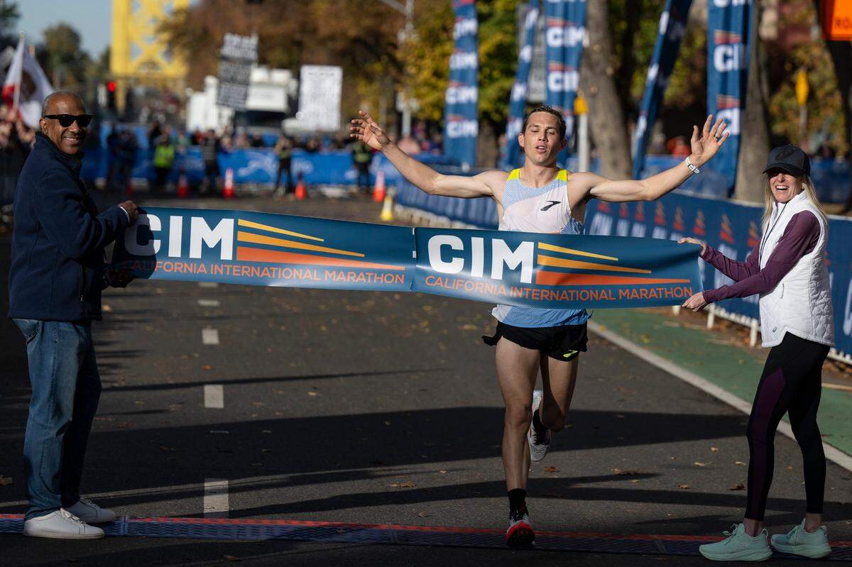 CJ Albertson, of Fresno, finishes first in the 40th California International Marathon from Folsom to the state Capitol in downtown Sacramento, on Sunday, Dec. 3, 2023.