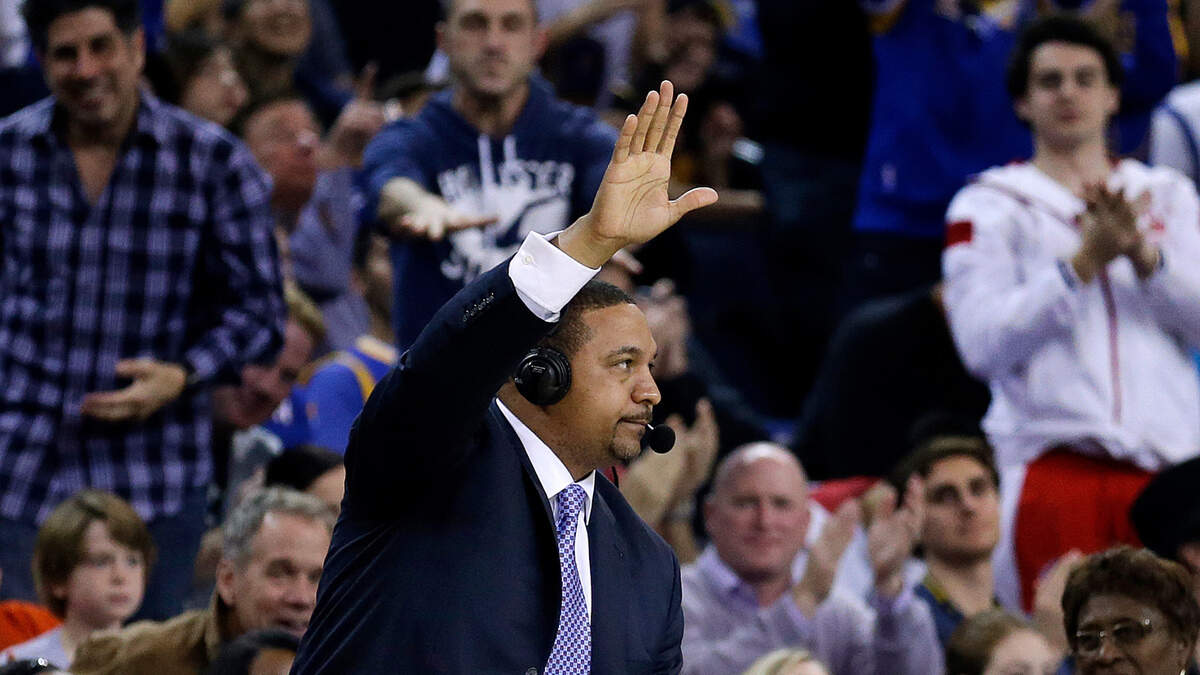 Former Golden State Warriors coach Mark Jackson acknowledges a standing ovation from fans during the first half of the Warriors’ NBA basketball game against the Cleveland Cavaliers Friday, Jan. 9, 2015, in Oakland, Calif. Jackson was working the game for ESPN. (AP Photo/Ben Margot)