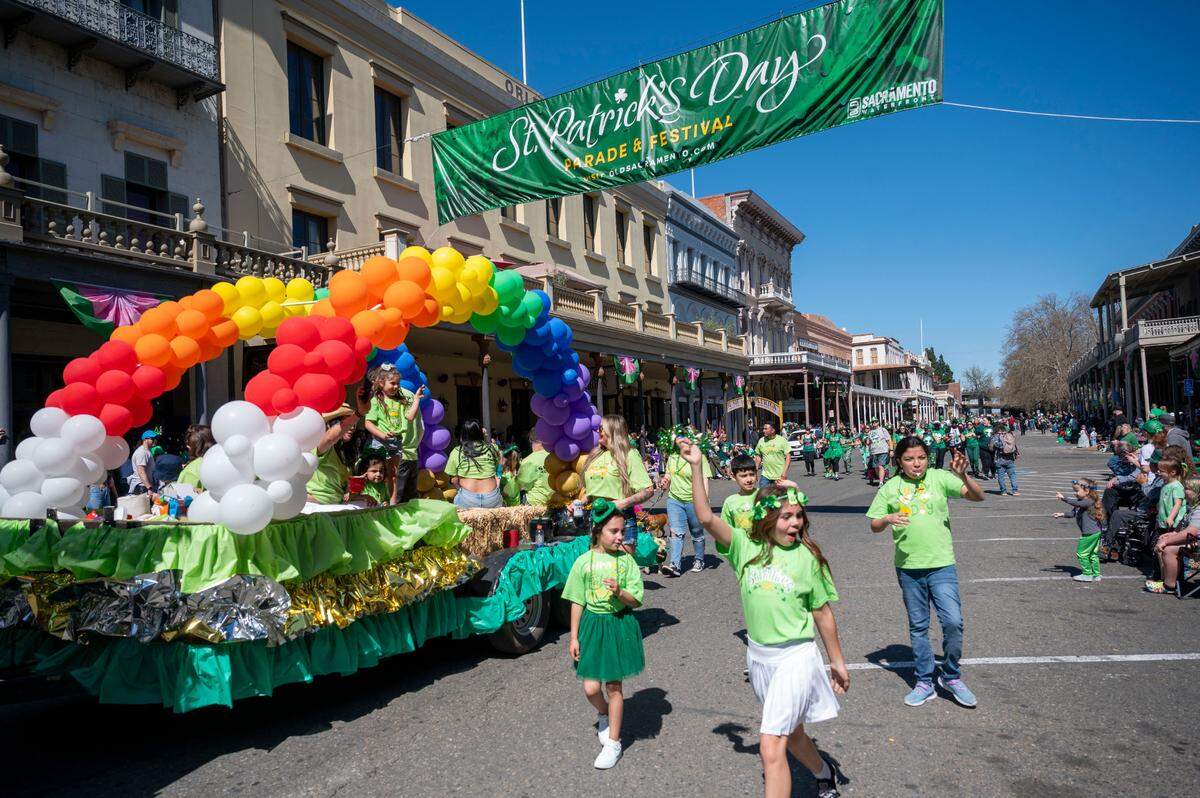 A rainbow float from Simp’s Junk Removal makes it way down Front Street during the St. Patrick’s Day parade in Old Sacramento on Saturday, March 16, 2024.