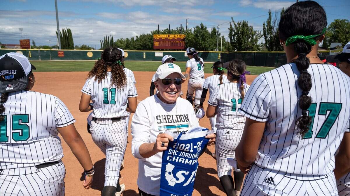 Sheldon High School Huskies coach Mary Jo Truesdale holds a section title banner in 2022. Her team is in the hunt for another Delta League softball championship.