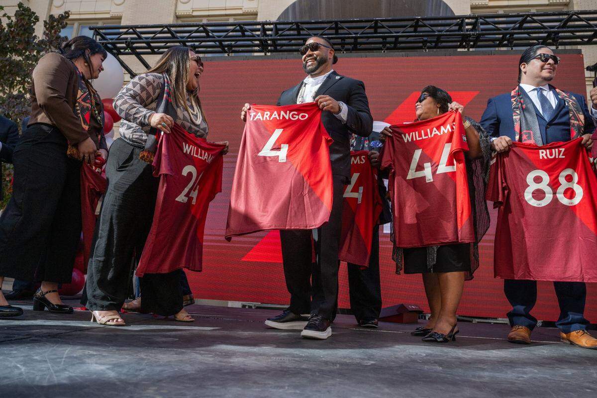 Wilton Rancheria Chairman Jesus Tarango (4) and vice-chair Raquel Williams (24) share a smile on Thursday, Nov. 7, 2024, as they hold custom Sacramento Republic FC jerseys after the announcement that the tribe is now the majority owner of the team and will help fund a new soccer stadium.