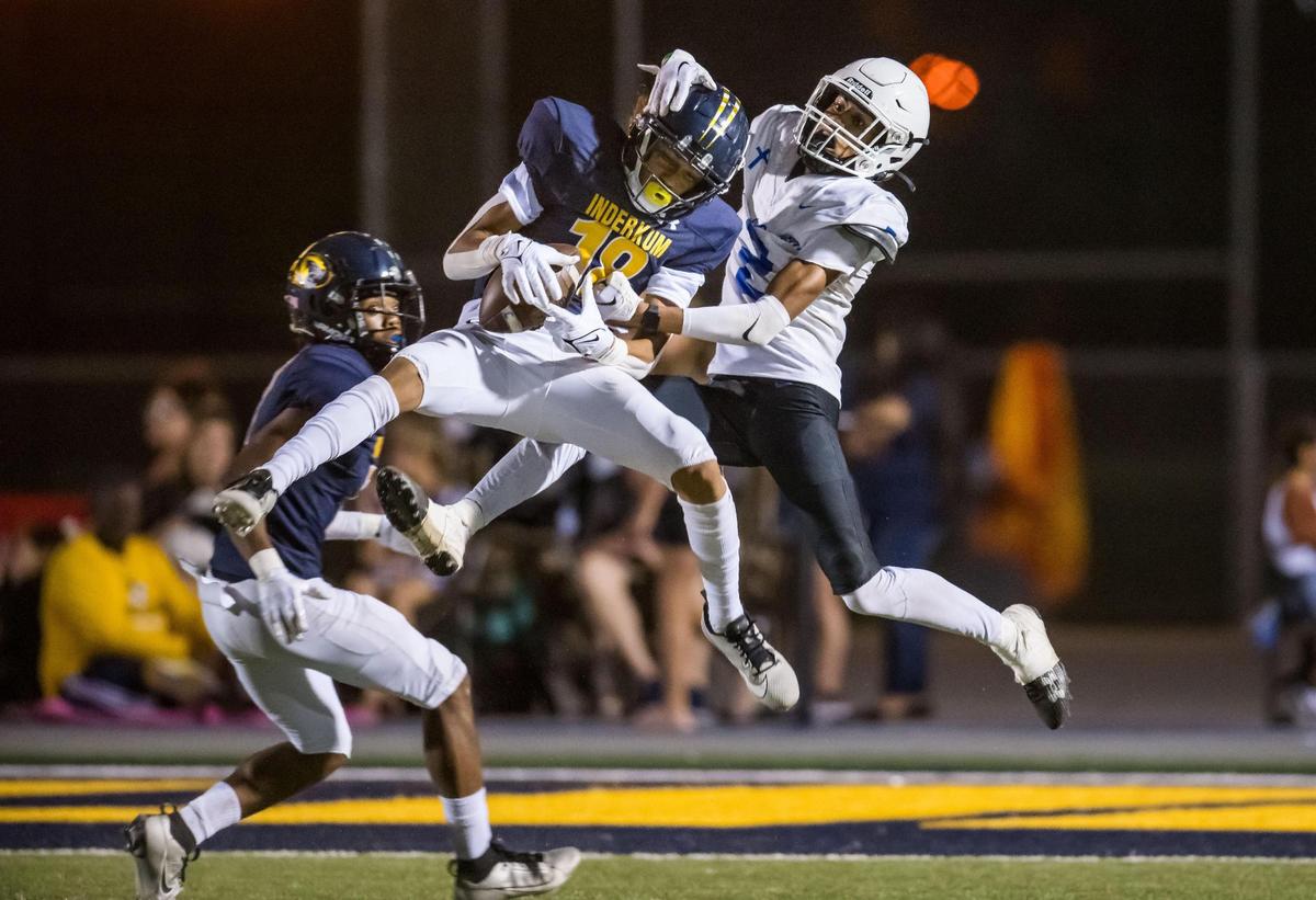 Inderkum Tigers defensive back Lono Chouteau (18), center, intercepts a pass intended for Capital Christian Cougars wide receiver Titus White (2) in 2023. Chouteau is joining the Sacramento State footbal team.