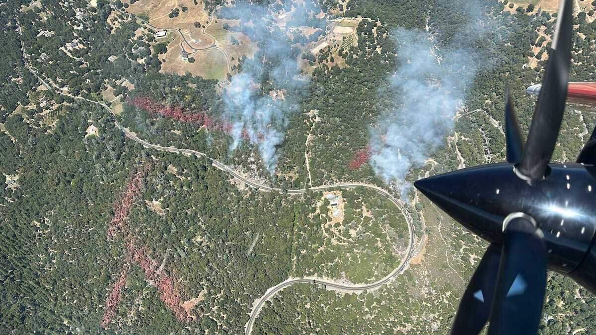 The Happy Fire, seen from a Cal Fire firefighting aircraft, burns near Mount Aukum Road southeast of Placerville on Tuesday. The vegetation fire prompted evacuation orders and warnings as firefighters worked to contain the blaze.