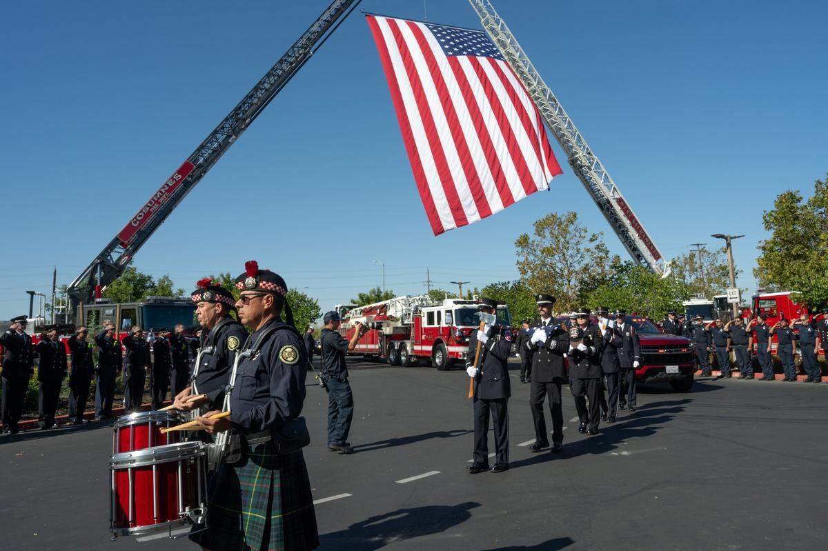 A procession carries the ashes of firefighter Tim Hall at his memorial service at Creekside Church in Elk Grove on Tuesday.