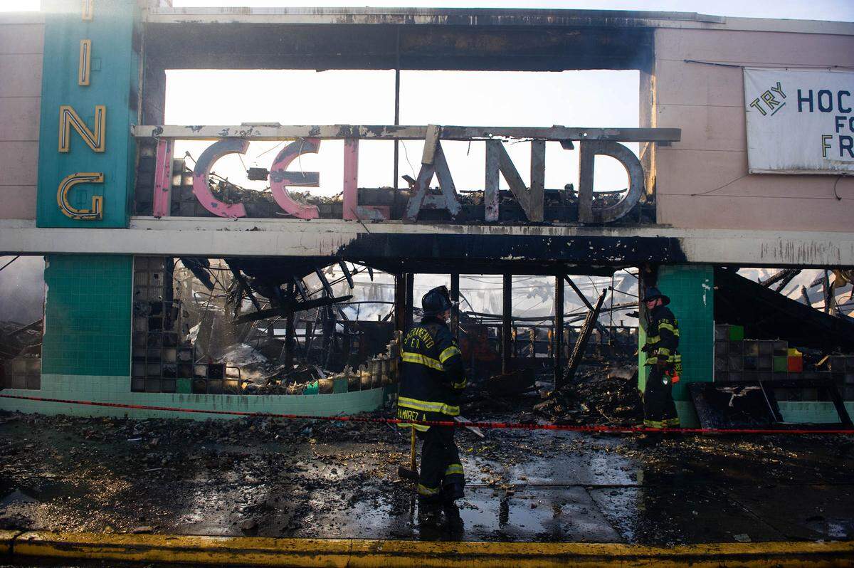 Sacramento firefighters mop up after a fire burned the Iceland Ice Skating Rick in North Sacramento on March 28, 2010.