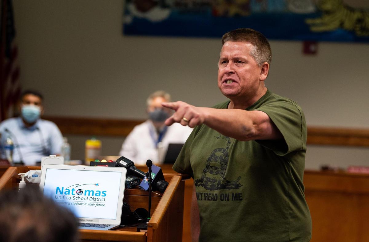 David Aria speaks to the crowd, echoing anger from parents and others in attendance towards the Natomas Unified School District board members, during a meeting in 2021 at the district headquarters in Natomas. SB 1100 amends the Brown Act to provide clarification regarding the authority of a local agency’s governing body to remove a disruptive member of the public from an open meeting, in order to maintain order during the meeting.