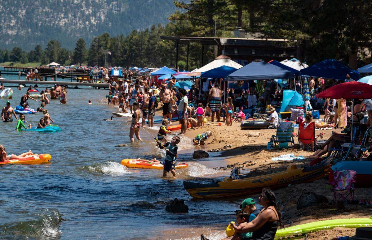 People flock to the shores of Lake Tahoe at Camp Richardson on a hot Saturday, July 11, 2020, in South Lake Tahoe.