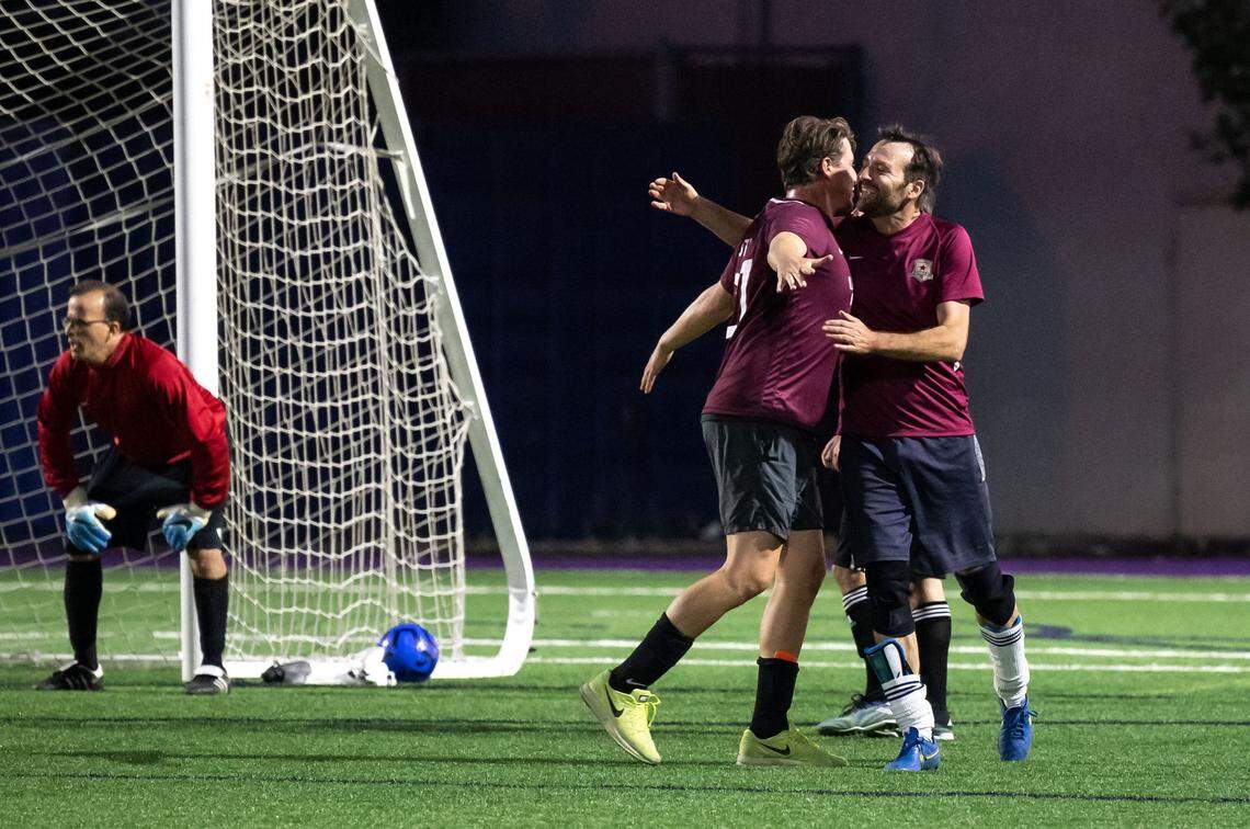 State Sen. Ben Allen, D-Santa Monica, right, celebrates a Southern California goal with fellow Sen. Henry Stern, D-Los Angeles, with a chest bump and hug as they play against Northern California in the annual Capitol Cup charity soccer game Wednesday at Cristo Rey High School in Sacramento.