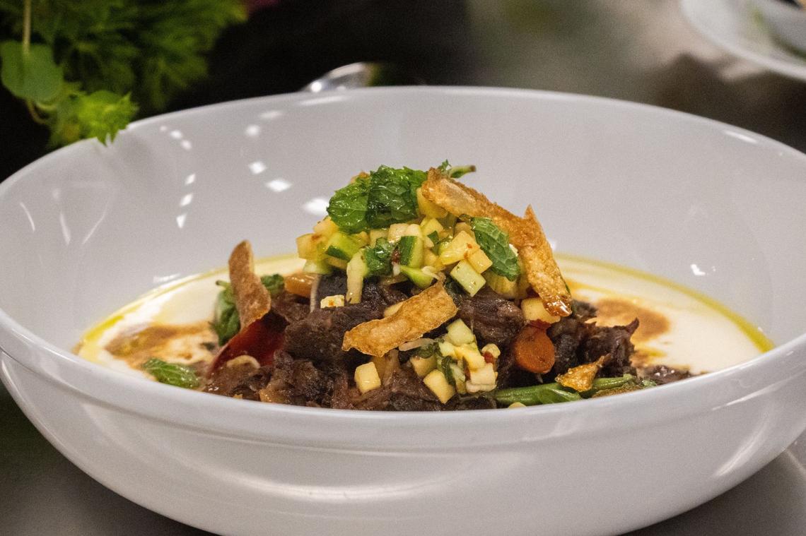 Goat tagine sits on display during this year’s Tower Bridge Dinner menu preview at the Central Kitchen in Sacramento on Monday, Aug. 12, 2024. This fourth course dish by executive chef Katerina Balagian contains elements including chilled celery root puree and Shirazi salad.