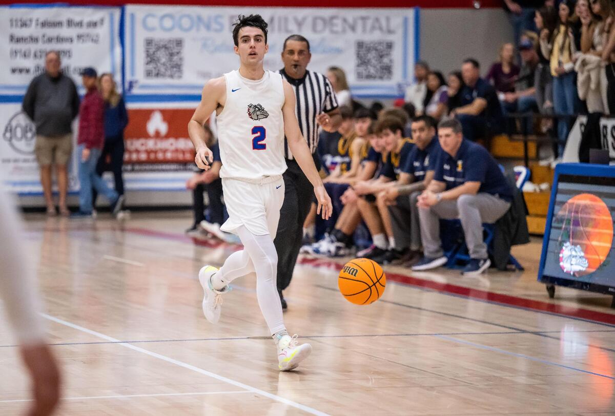Folsom Bulldog guard Micah Johnston (2) dribbles downcourt during the fourth quarter against Oak Ridge during the high school boys basketball Sierra Foothill League game Friday, Feb. 10, 2023, at Folsom High School. Folsom celebrated senior night as they defeated Oak Ridge 70-51.