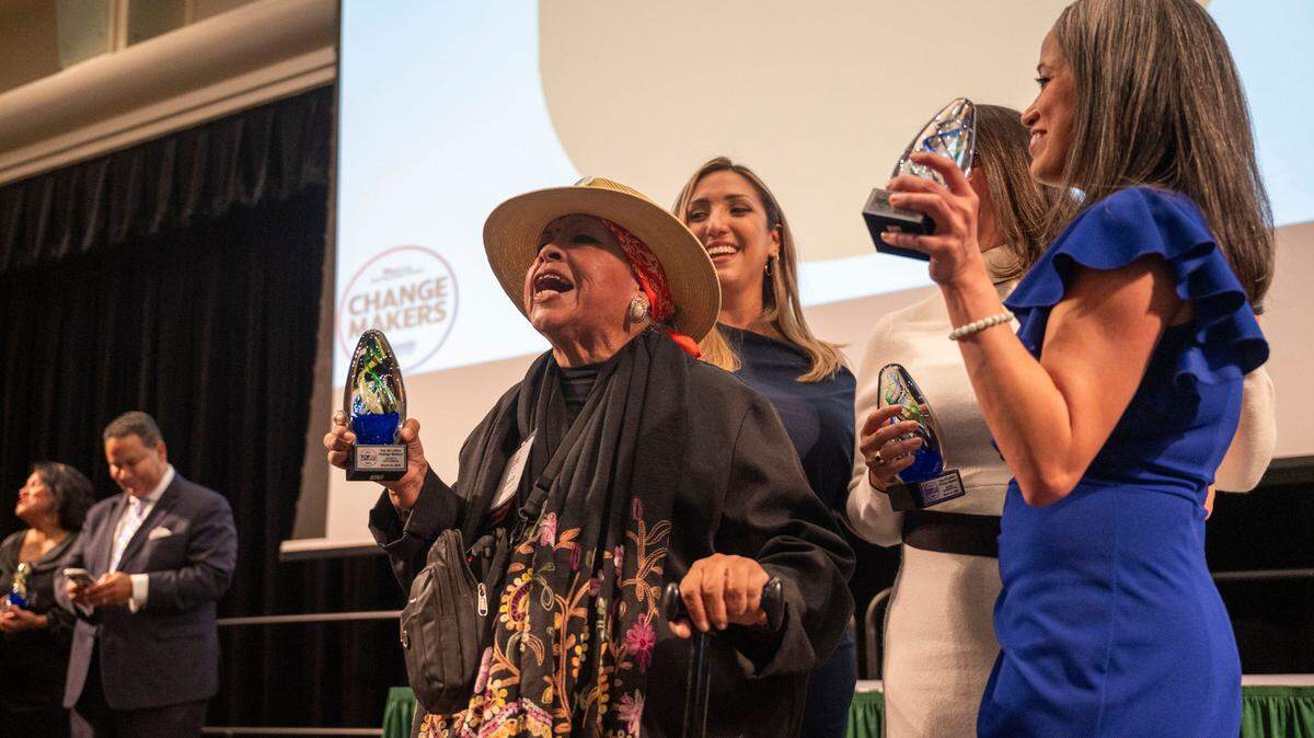 Latino Change Maker Juanita Polendo Ontiveros, center, celebrates on stage with Lisa Cardozo, right and others as The Sacramento Bee’s Equity Lab and the Nehemiah Emerging Leadership Program hosted the latest 60 leaders at an event held at Sacramento State on Friday, March 22, 2024.