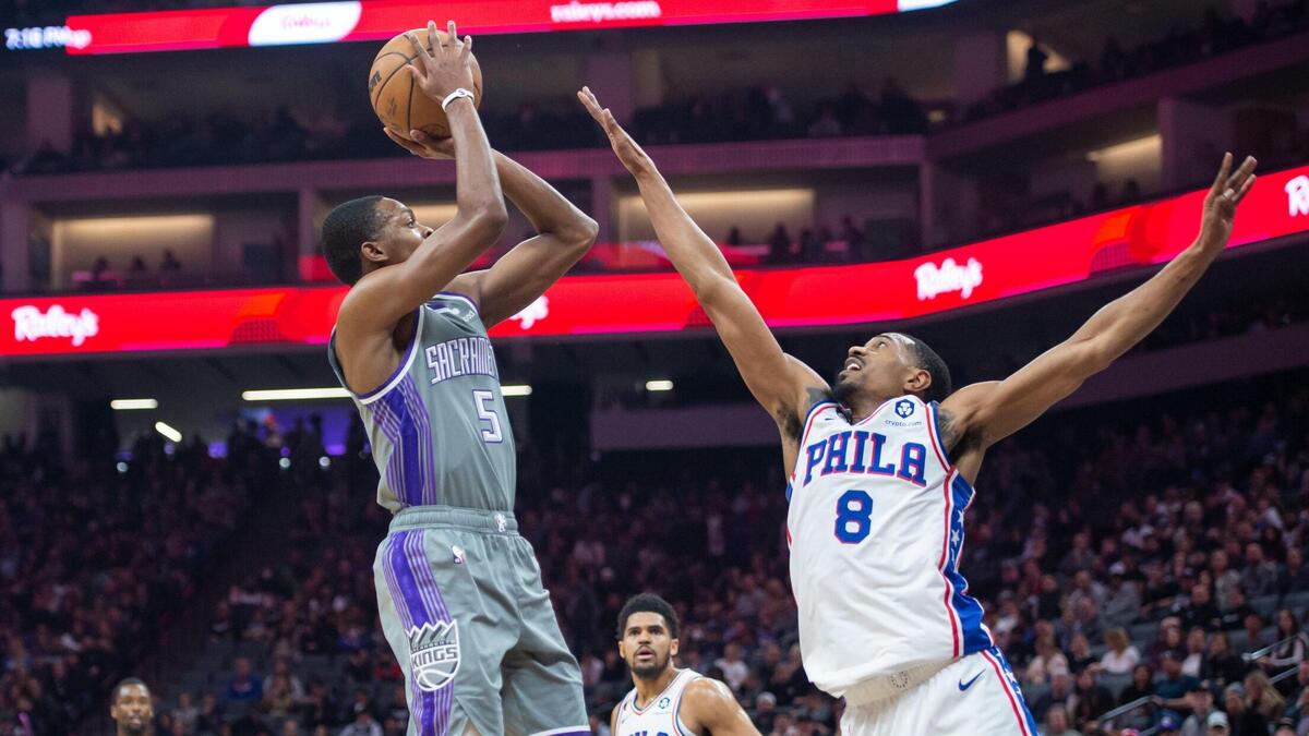 Sacramento Kings guard De’Aaron Fox (5) makes an 11-foot pull-up jump shot over Philadelphia 76ers guard De’Anthony Melton (8) during the first half in the NBA basketball game Saturday, Jan. 21, 2023, at the Golden 1 Center in Sacramento.