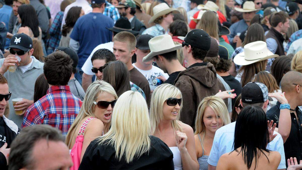 (BART AH YOU/bahyou@modbee.com) The Oakdale Rodeo isn’t just a livestock event but a place where cowboy and cowgirl pheromones flow as much as the beer. People gather next to the watering hole. April 10, 2010