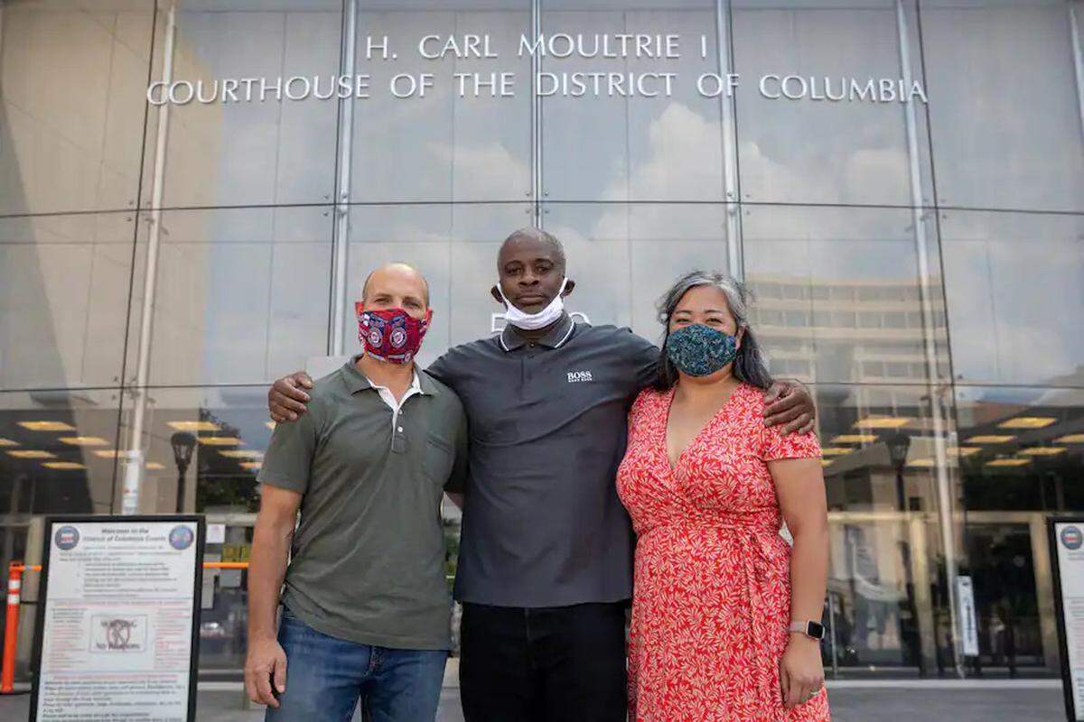 Troy Burner, center, stands outside D.C. Superior Court with two of his attorneys in August 2020 after a court ruling.