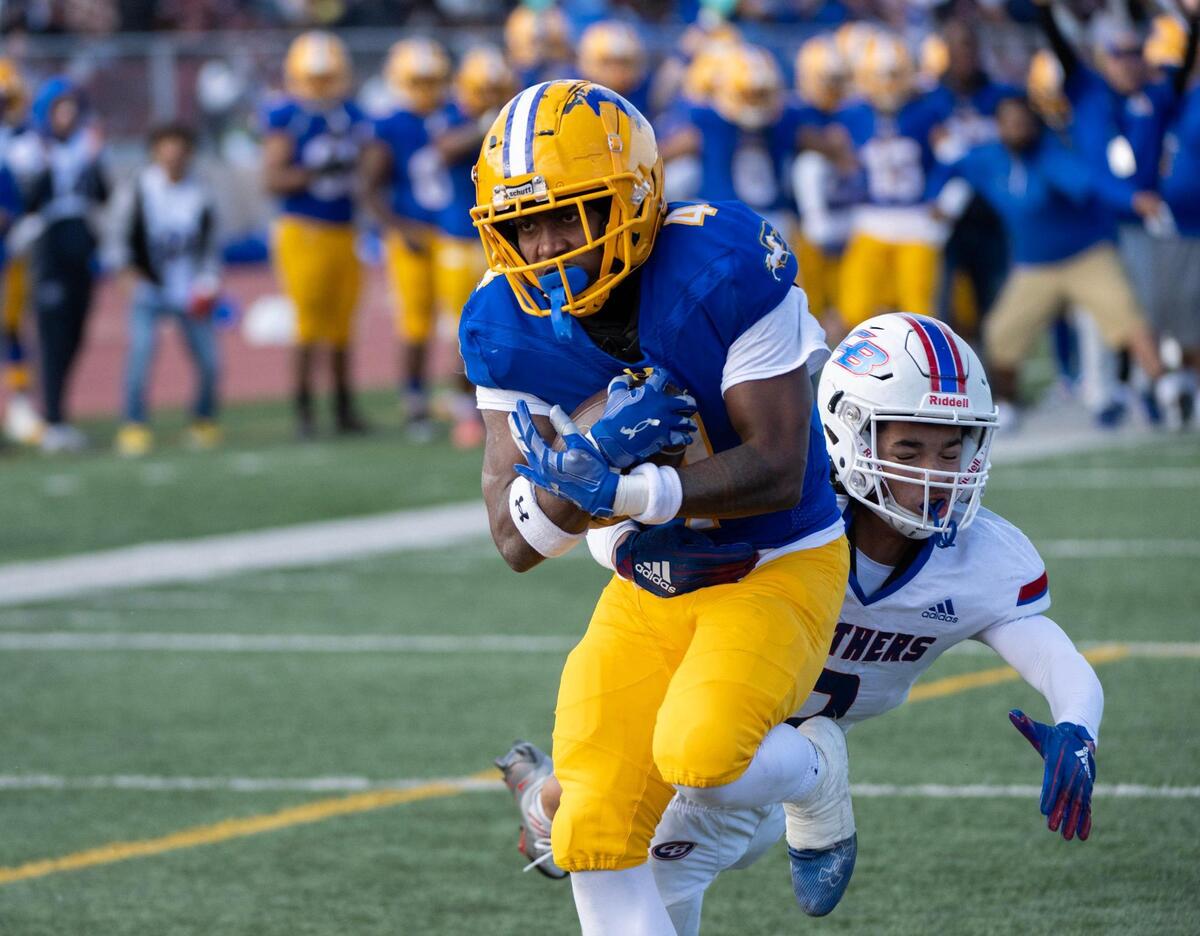 Grant High School’s Semaj Mafu-Hart breaks a tackle by Christian Brothers’ Isaiah Jordan to score touchdown for a 12-6 lead in the first half during the CIF Sac-Joaquin Division III section championship at Hughes Stadium in Sacramento on Friday, Nov. 25, 2022.