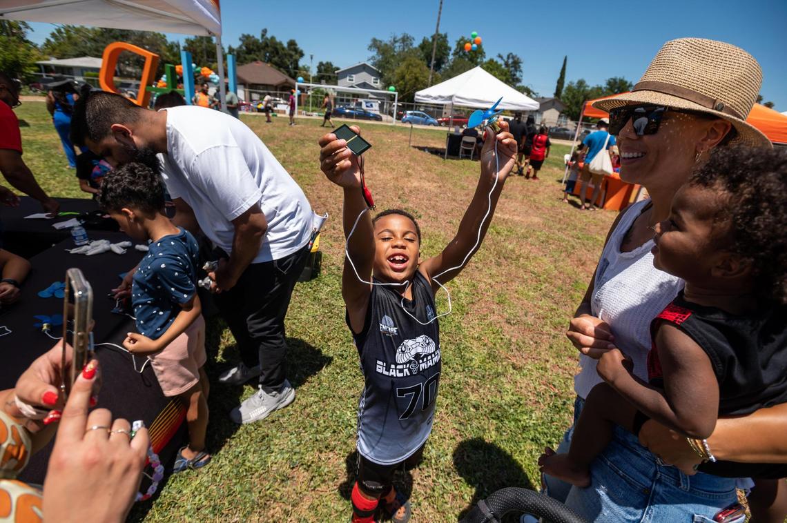 Jay Johnson, 7, of Natomas, holds up a small fan powered by a solar power he assembled at a table operated by SMUD during Square Root Academy’s H@ck the Park outdoor festival Saturday at Maple Park in Sacramento.