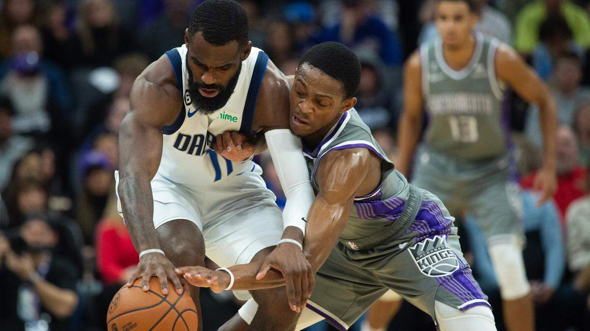 Sacramento Kings guard De’Aaron Fox (5) battles Dallas Mavericks forward Tim Hardaway Jr. (11) for control of the ball in the second quarter during a game at the Golden 1 Center in Sacramento, Friday, Feb. 10, 2023.