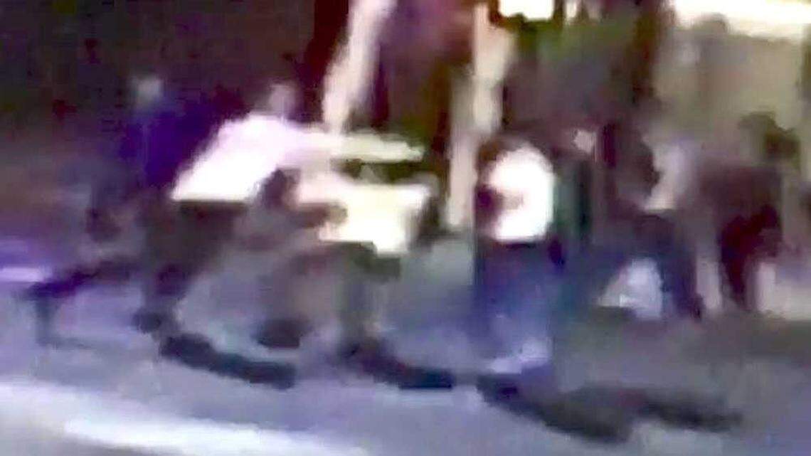 In this cropped screen capture of a surveillance video pointed at 21st and K streets in midtown Sacramento early Thursday, Oct. 8, 2015, Spencer Stone, believed to be the man in a white shirt on the left taking a swing in this frame, is seen fighting two unknown men. Stone was stabbed in the incident and hospitalized.