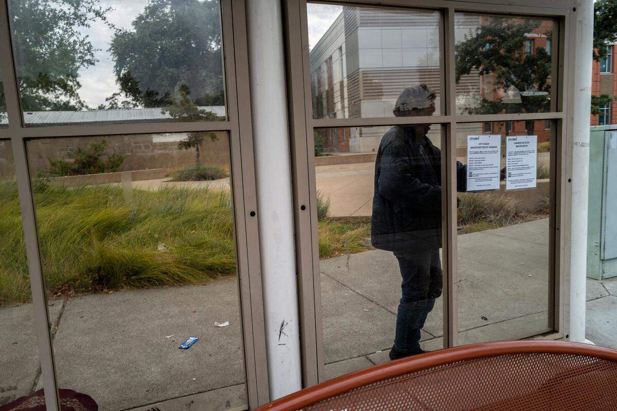 Mark Rippee goes behind a bus stop in Vacaville to urinate in a cup and complains there are no bathrooms near where he stays in Vacaville.
