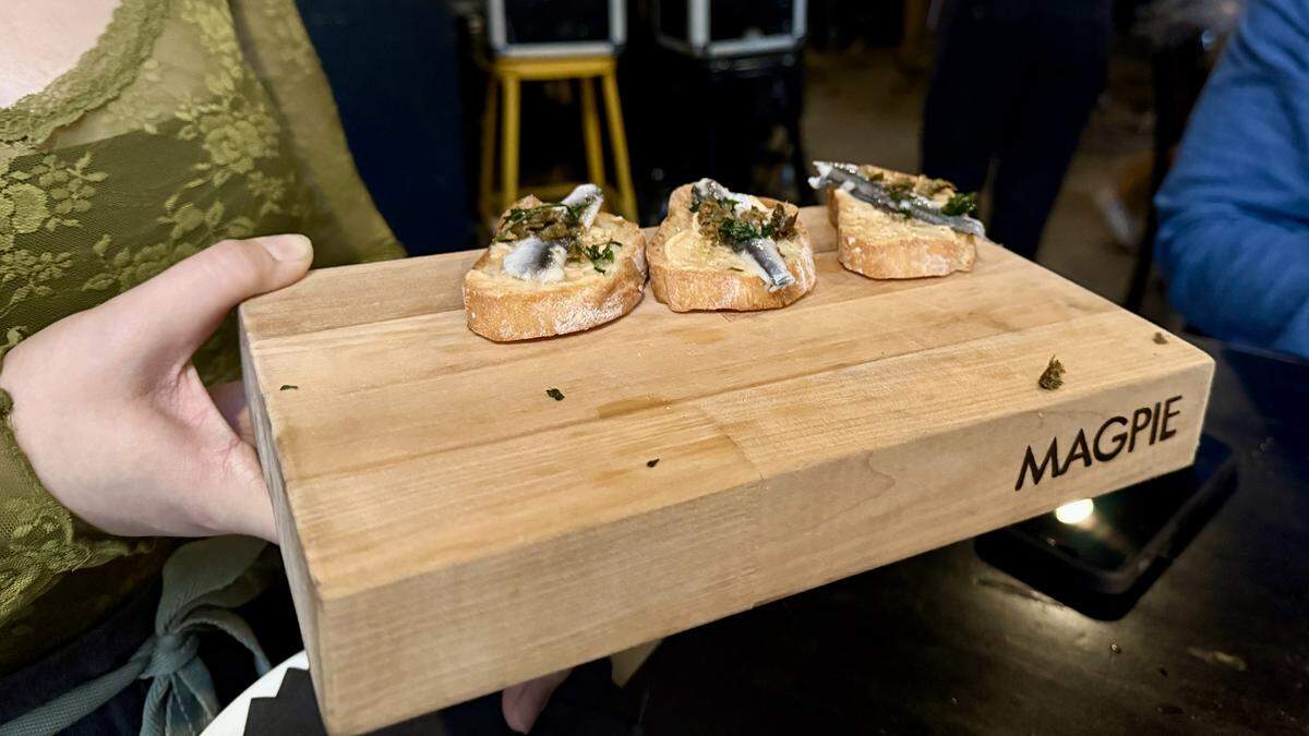 A server passes Sardine crostini as a bite at Magpie Cafe’s in Sacramento. The farm-to-fork restaurant celebrated its 21st anniversary, on April 1, 2026, with an event serving free food to locals and industry folk.
