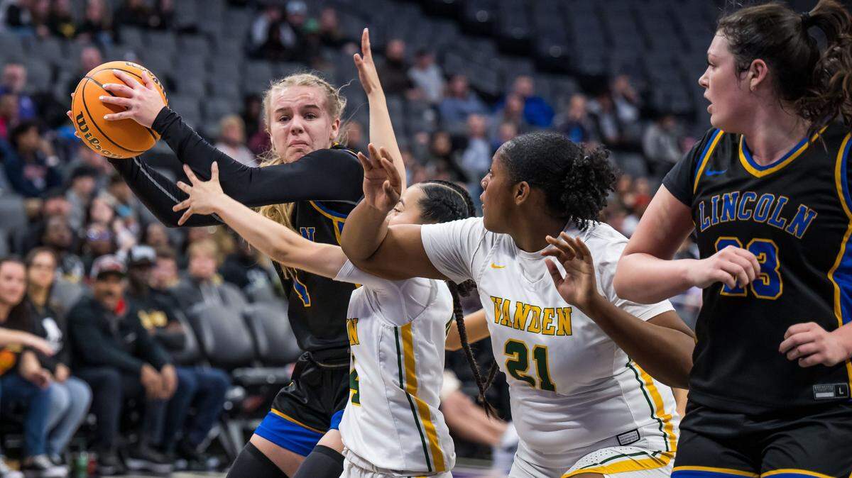 The Lincoln Fighting Zebras’ Maya Hodge, left, is closely defended by the Vanden Vikings’ Jaylen Kuehnel (4) during the Division III girls basketball section final game Saturday.