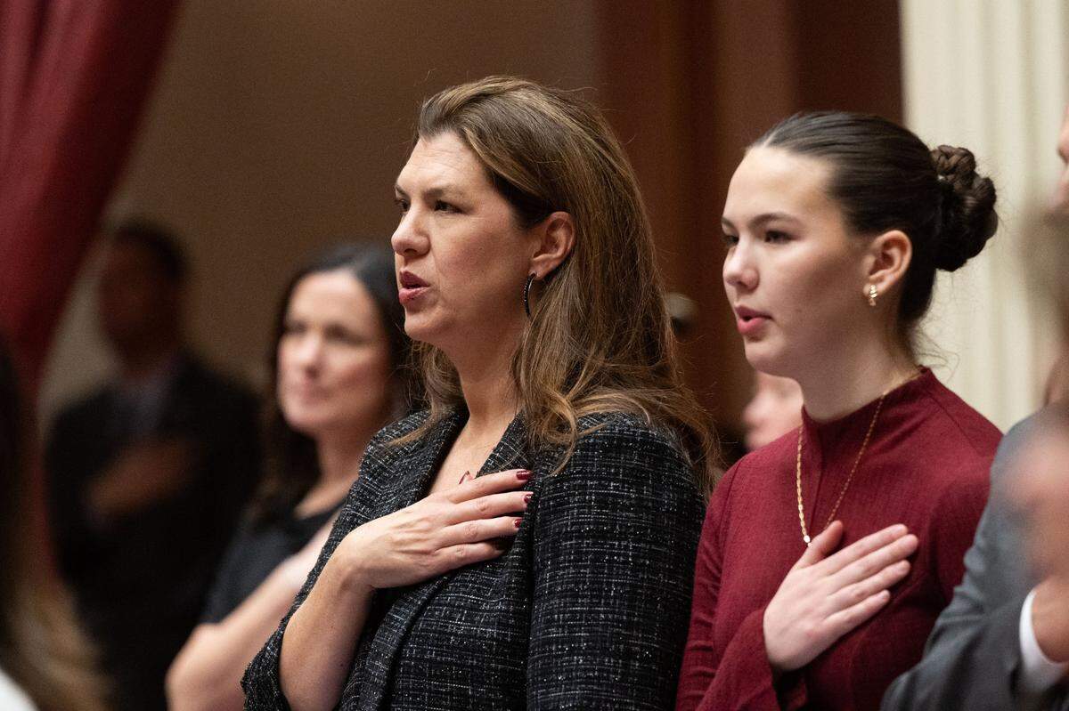 State Sen. Megan Dahle, R-Bieber, and her daughter Roslyn stand for the Pledge of Allegiance on Monday during the first day of session at the state Capitol.