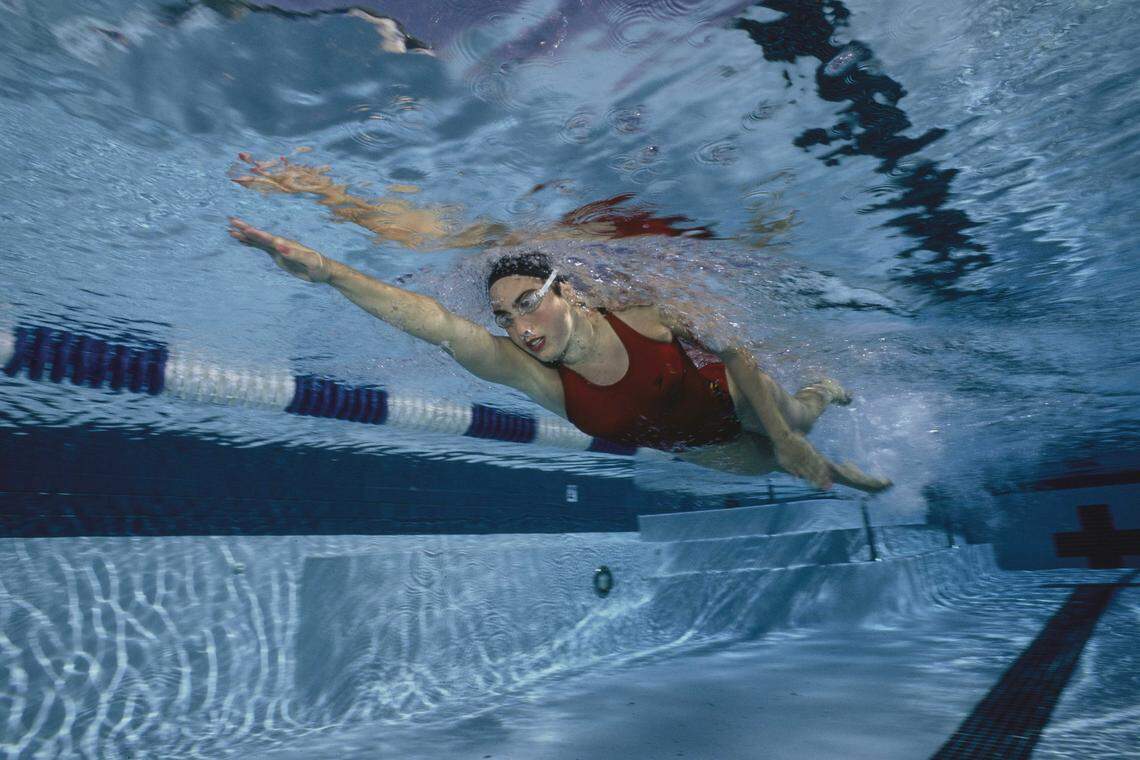 Olympic gold medalist Janet Evans swims freestyle underwater at the University of Texas in Austin, Texas, on Sept. 25, 1991. Evans, a four-time Olympic gold medalist who now serves as chief athlete officer for the 2028 Los Angeles Olympic Games, is being inducted into the California Hall of Fame.