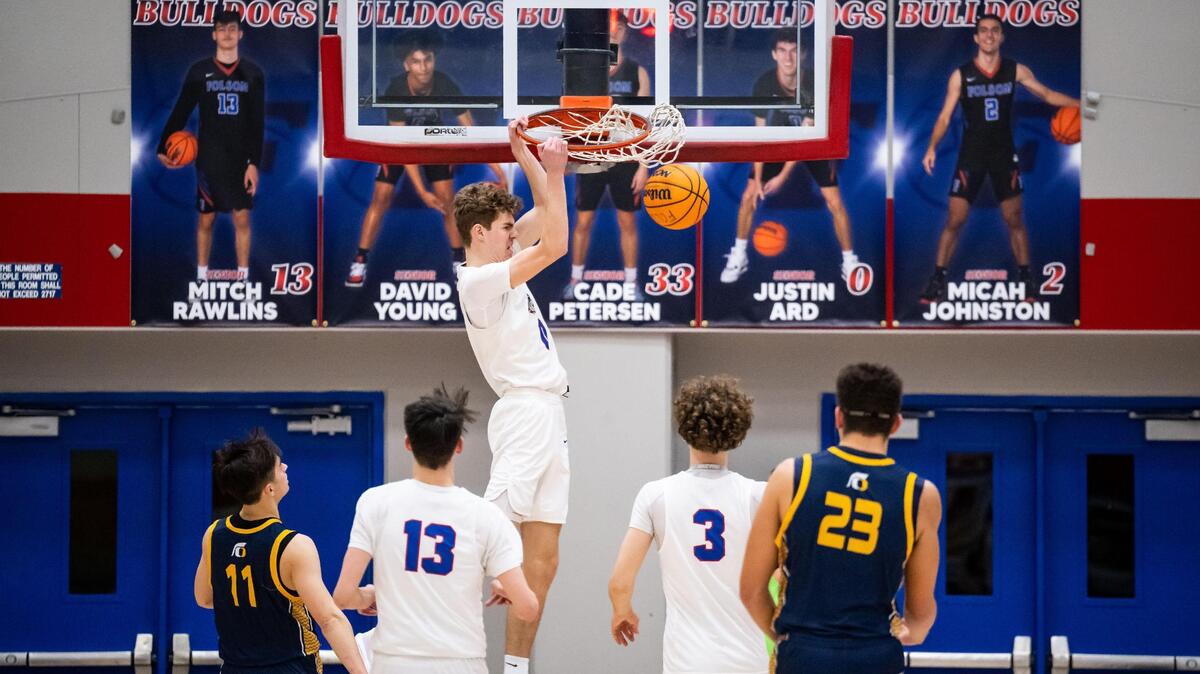 Folsom Bulldog Justin Ard (0) dunks the ball with emphasis during the first quarter against Oak Ridge during the high school boys basketball Sierra Foothill League game Friday, Feb. 10, 2023, at Folsom High School. Folsom celebrated senior night as they defeated Oak Ridge 70-51.
