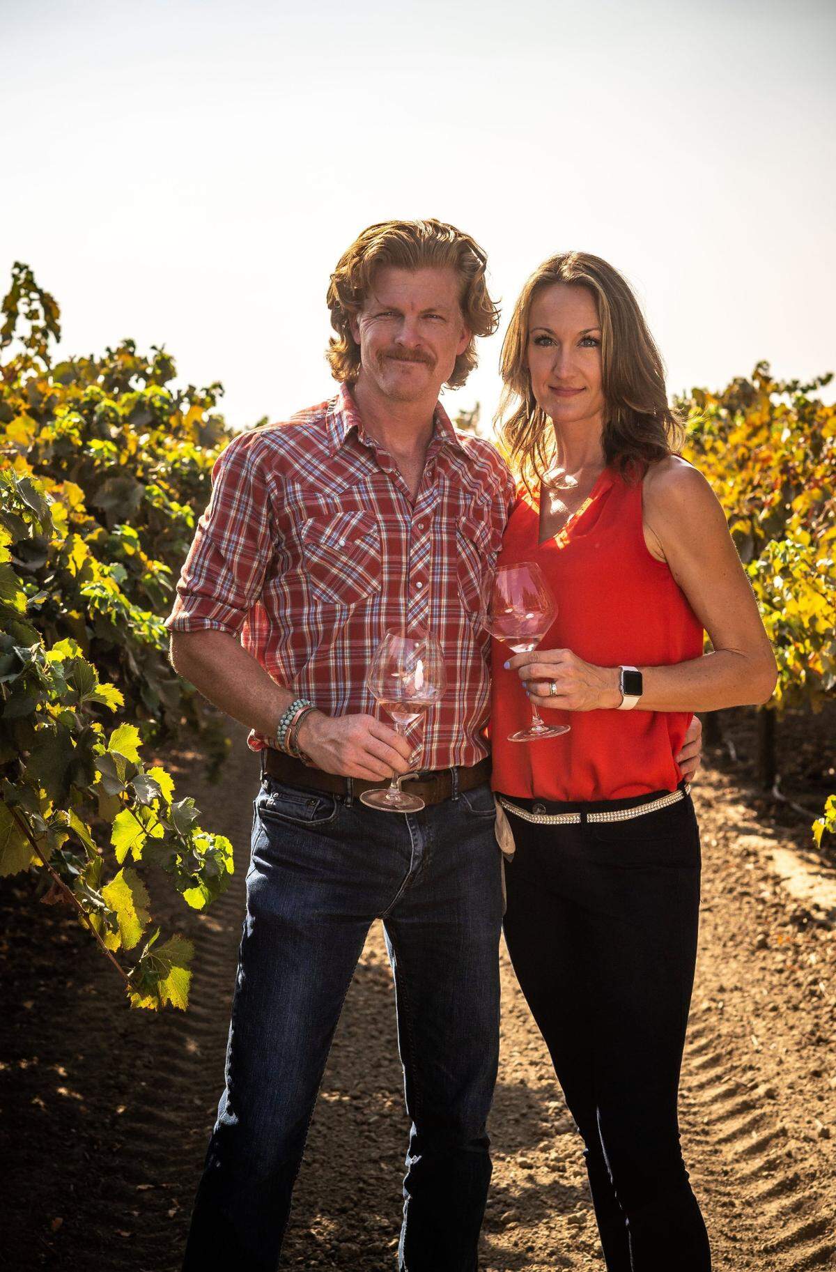 Phil Ogilvie, co-owner at Ogilvie Merwin Vintners, stands with his wife, Silt Wine Company hospitality director and tasting room manager Shannon Ogilvie, in their vineyard in Clarksburg.