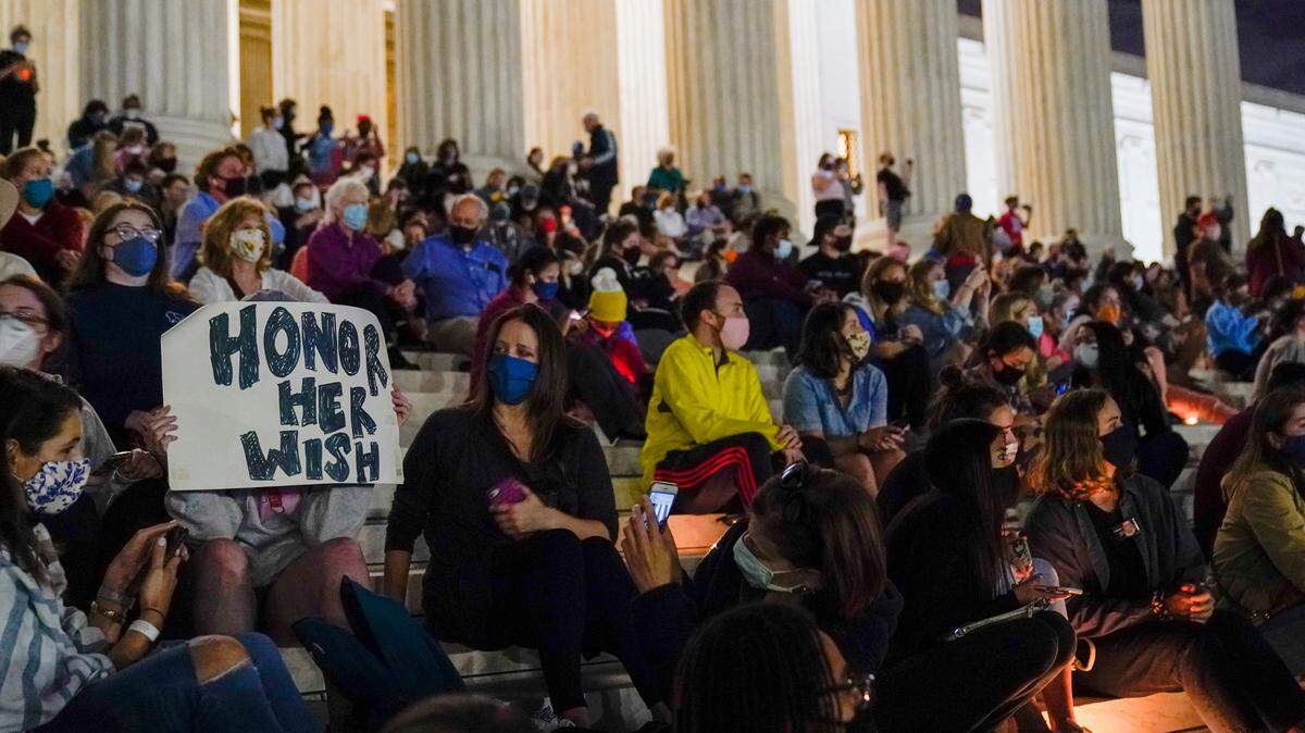 People gather at the Supreme Court Friday, Sept. 18, 2020, in Washington, after the Supreme Court announced that Supreme Court Justice Ruth Bader Ginsburg has died of metastatic pancreatic cancer at age 87. (AP Photo/Alex Brandon)