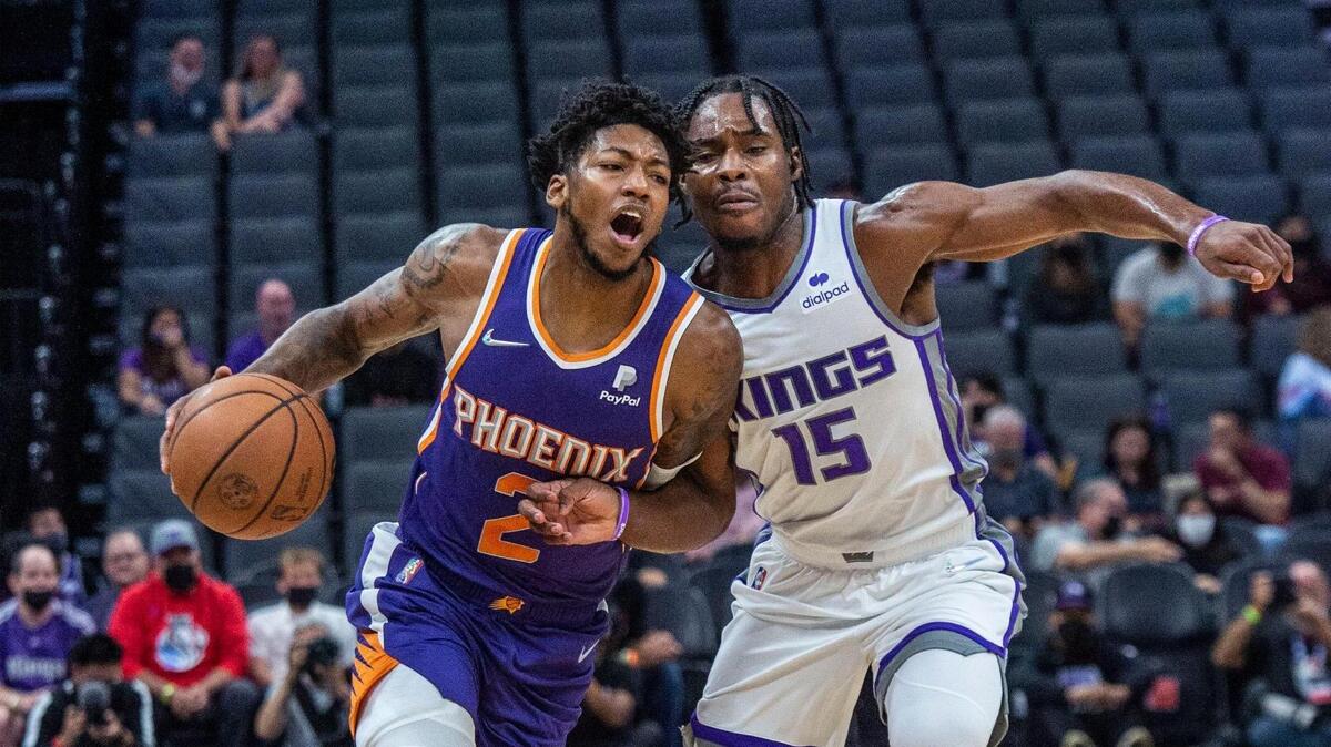 The Sacramento Kings’ Davion Mitchell (15) defends Alfred Payton (2) of the Phoenix Suns during the first quarter of an NBA preseason game on Monday, Oct. 4, 2021 at Golden 1 Center in Sacramento.