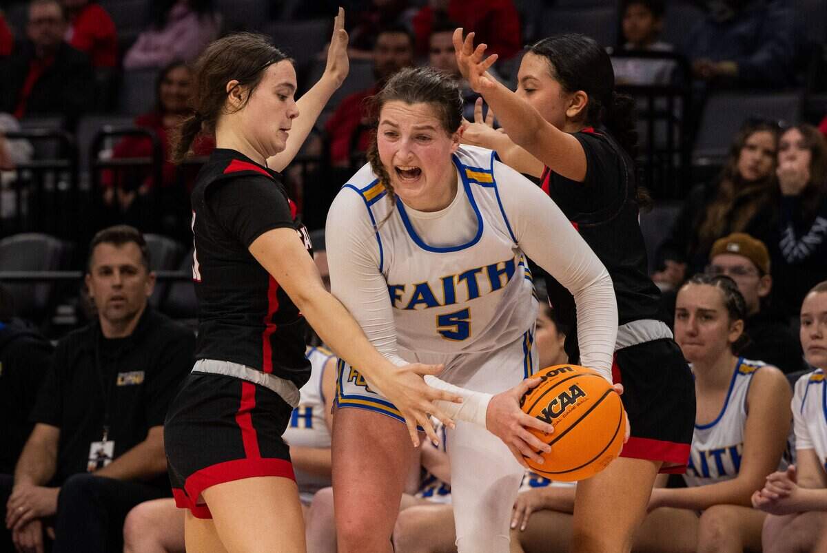 The Faith Christian Lions’ Lauren Harris (5) is defended by the Sacramento Adventist Capitals’ Kyla Friedrich (21) and Jasmine Rodriguez (2) during the 2025 CIF Sac-Joaquin Section Division VI girls basketball championship game at Golden 1 Center.