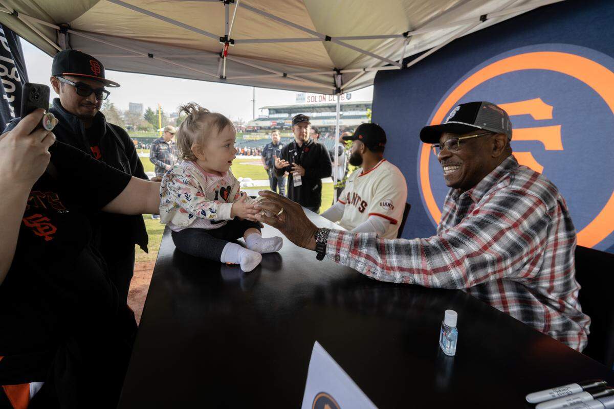 Former San Francisco Giants manager Dusty Baker shares a moment with Jordyn Gant of Vacaville at the Giants Fanfest at Sutter Health Park in West Sacramento on Saturday.