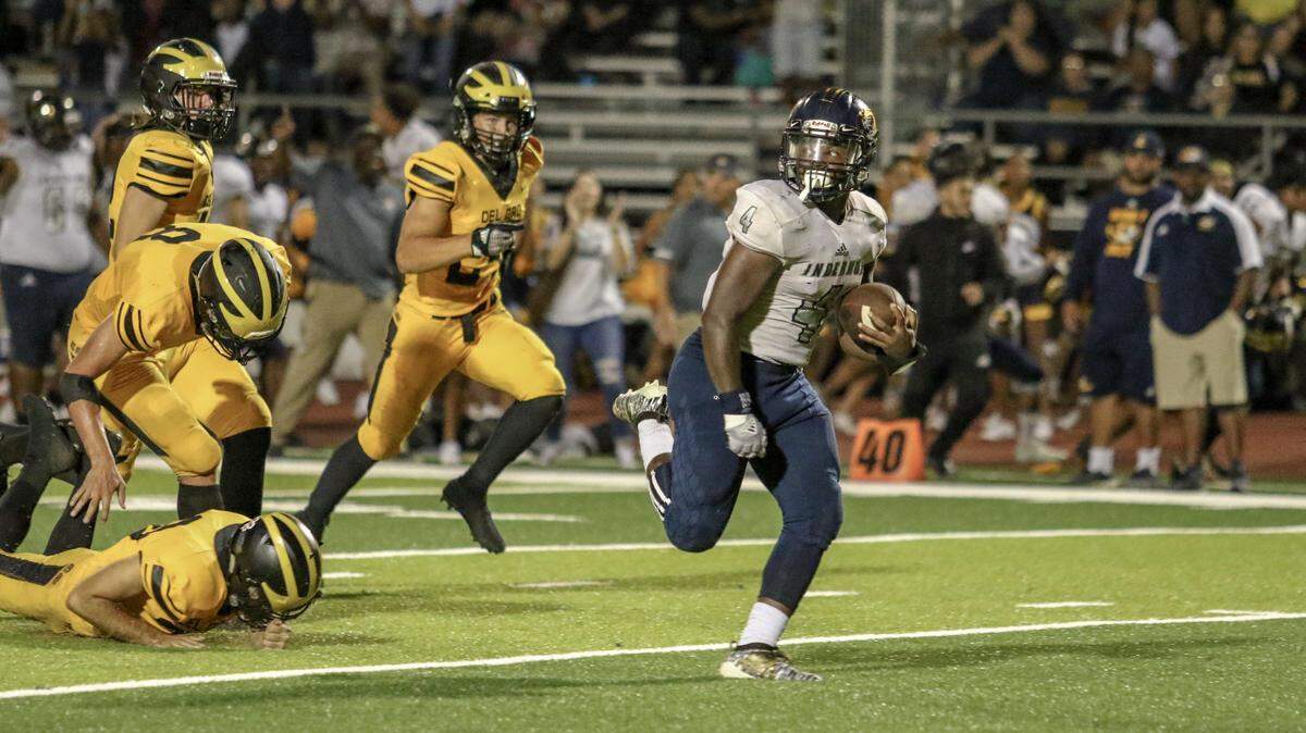 Inderkum’s Josiah Tyes outruns a gaggle of Del Oro defenders during his team’s 37-10 win Friday night.