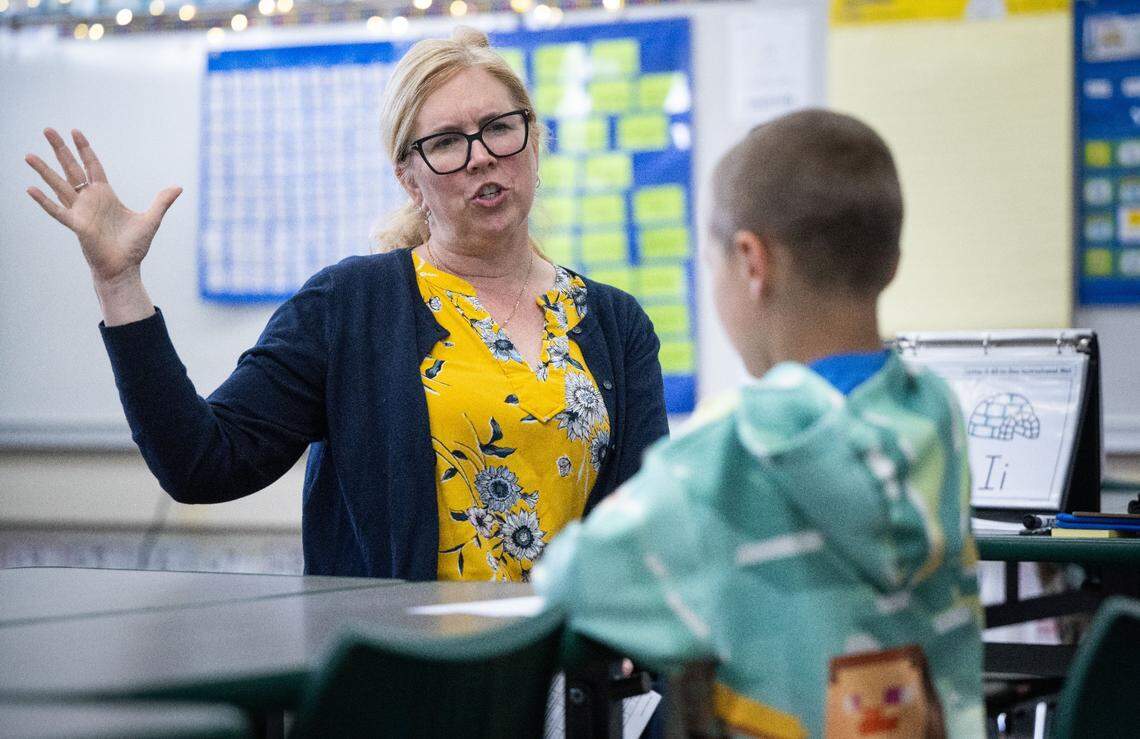 Second grader Jaxon, 8, is tutored in reading by intervention teacher Brittney Groess on Thursday at Thomas Kelly Elementary.