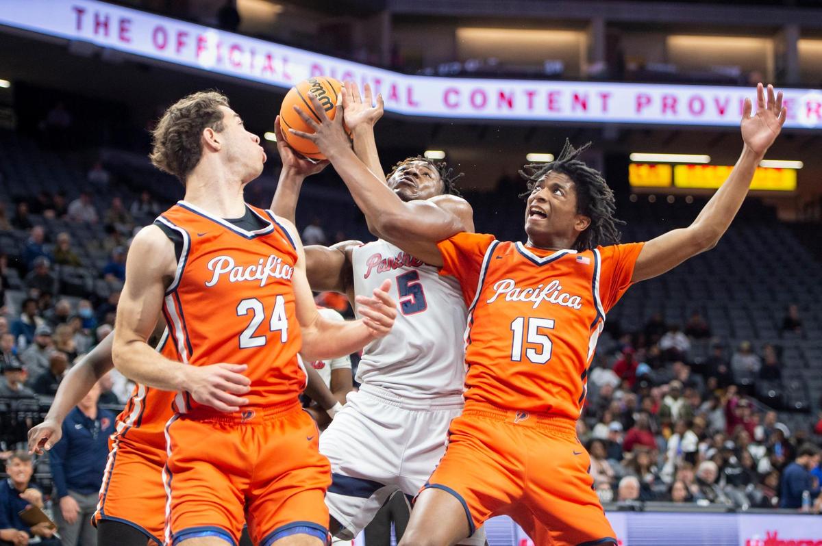 San Joaquin Memorial forward Mike Davis Jr. (5) draws a foul on Pacifica Christian Tritons Jeffry Bohlinger (15) and makes one of the free throws in the first half in the CIF State Division II Boys Basketball Championships on Saturday, March 11, 2023, at Golden 1 Center in Sacramento.