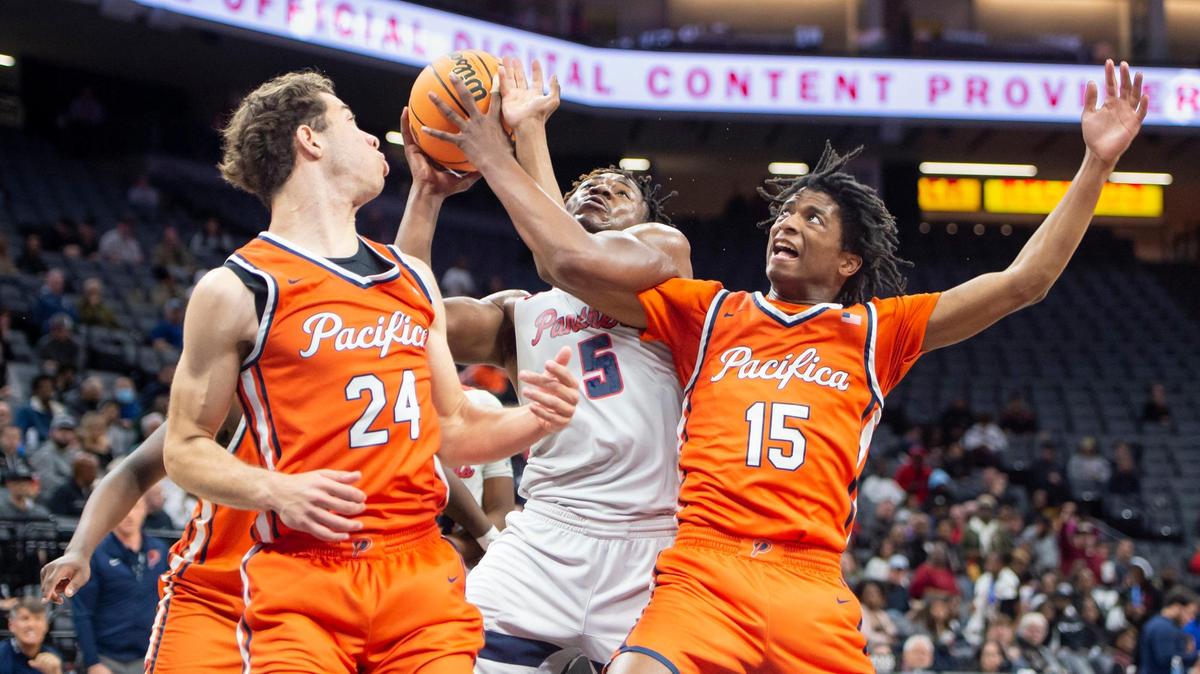 San Joaquin Memorial forward Mike Davis Jr. (5) draws a foul on Pacifica Christian Tritons Jeffry Bohlinger (15) and makes one of the free throws in the first half in the CIF State Division II Boys Basketball Championships on Saturday, March 11, 2023, at Golden 1 Center in Sacramento.