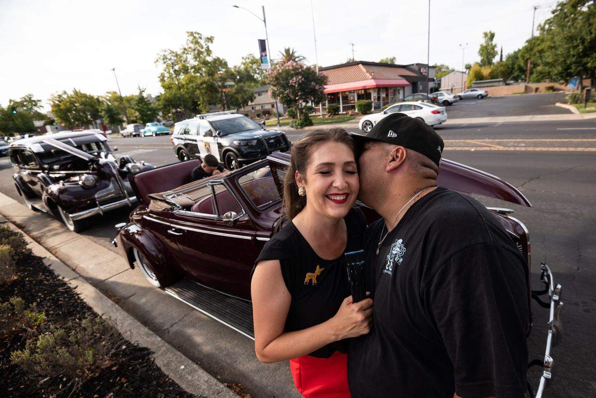 ShaVolla Rodriguez, left, and her husband, Carlos, took a break from cruising in Sacramento in two of their classic cars on Saturday, July 31, 2021.